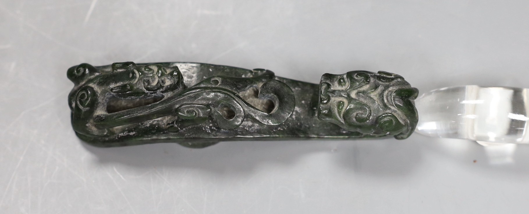 A Chinese rock crystal belt hook and a Chinese spinach green jade belt hook (2), largest 12cms long